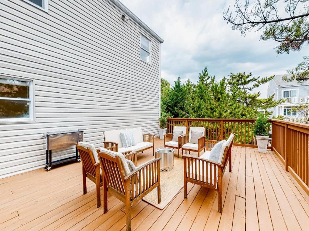 image Expansive deck offering ample seating for dining al fresco or soaking up the sun, making it the perfect spot to savor coastal breezes.