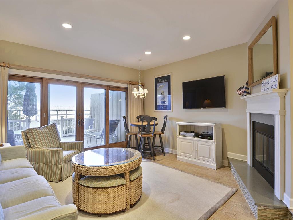 image Cozy living room with a raised hearth fireplace and comfortable seating, perfect for relaxation after a beach day.