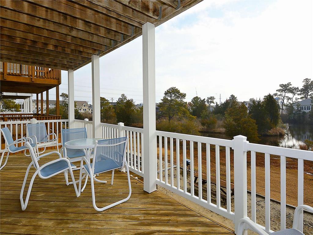 image Spacious balcony with outdoor seating, offering serene views of the surrounding area.