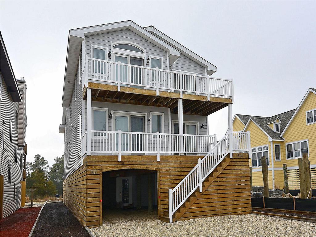 image Spacious three-story home with a charming balcony and ample outdoor space, perfect for relaxing near the canal.