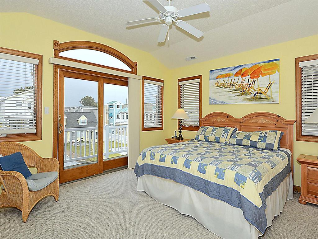 image Bright and cozy bedroom with a private balcony and plenty of natural light, perfect for a peaceful retreat.