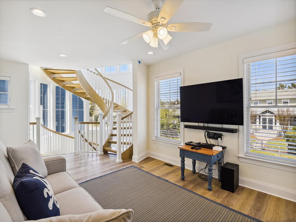 image Spacious living room on the first floor with natural light and comfortable seating, perfect for family gatherings or movie nights.