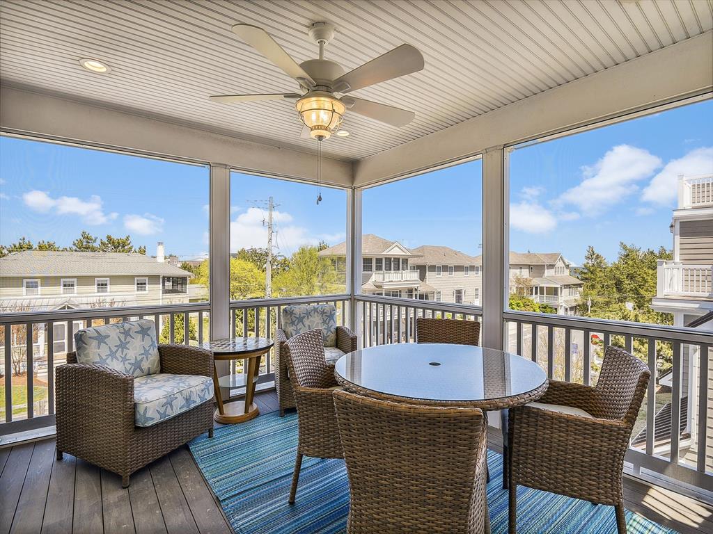 image Bright and airy screened porch with panoramic views, offering a serene spot to unwind and enjoy the surroundings.