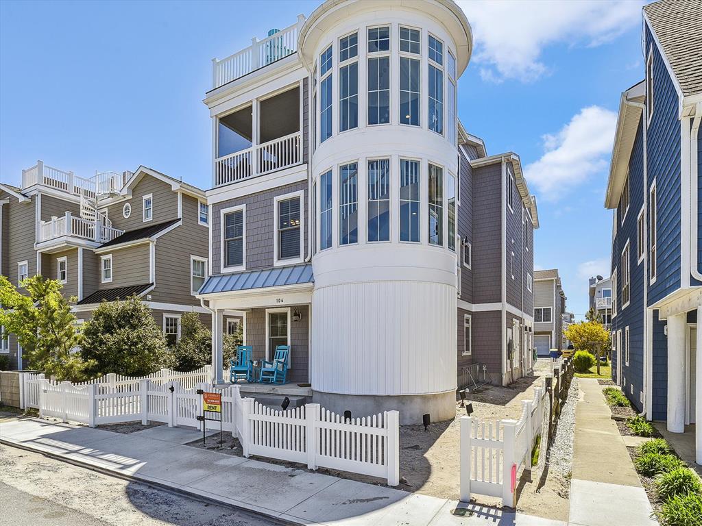 image Stunning exterior with a classic beach cottage design, located just 30 yards from beach access, perfect for a seaside retreat.