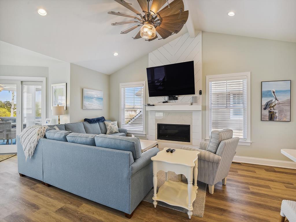 image Expansive living area with vaulted ceilings and stylish decor, offering a bright and airy ambiance.