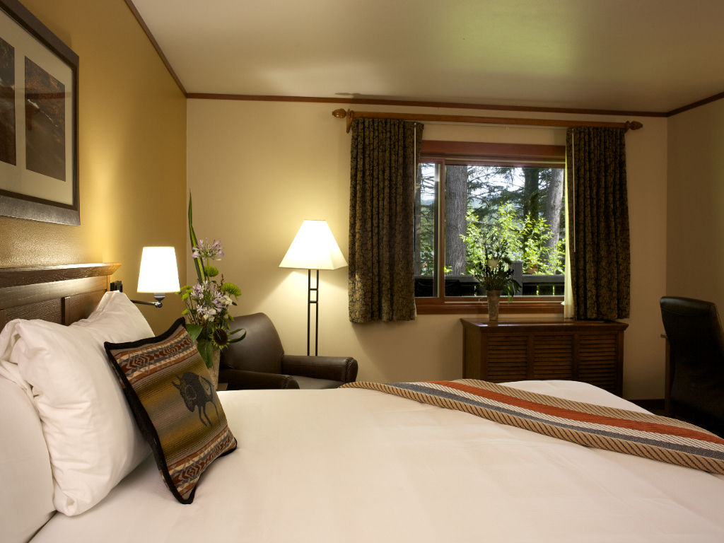 image A cozy, inviting bedroom with soft lighting and a view of nature, perfect for unwinding and relaxing.