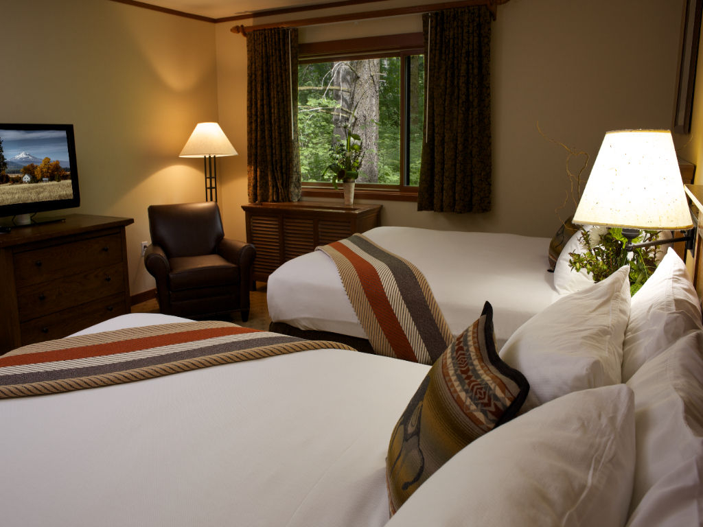image A restful space with plush bedding and soft lighting, offering a peaceful ambiance for unwinding.