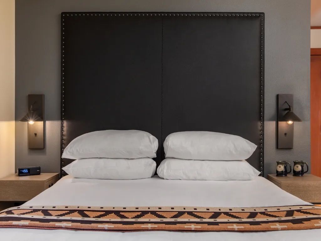 image A cozy, inviting space featuring a plush bed and soft lighting, creating the perfect spot for relaxation and unwinding.