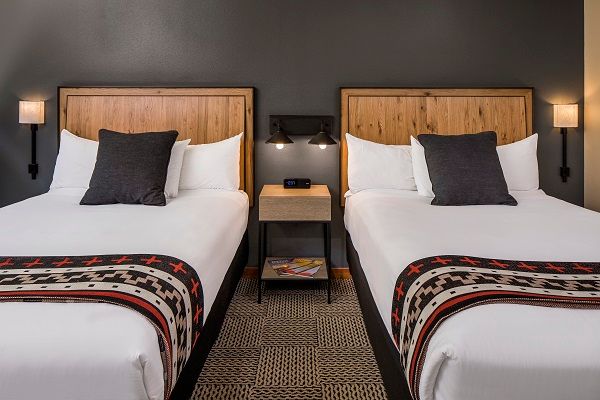image A cozy and stylish room with plush twin beds and soft lighting, designed for a peaceful night’s rest.