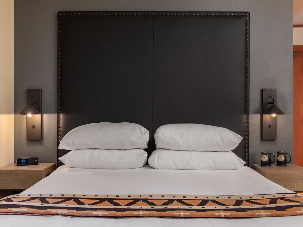 image A cozy and stylish space with soft bedding and ambient lighting, inviting relaxation and comfort.