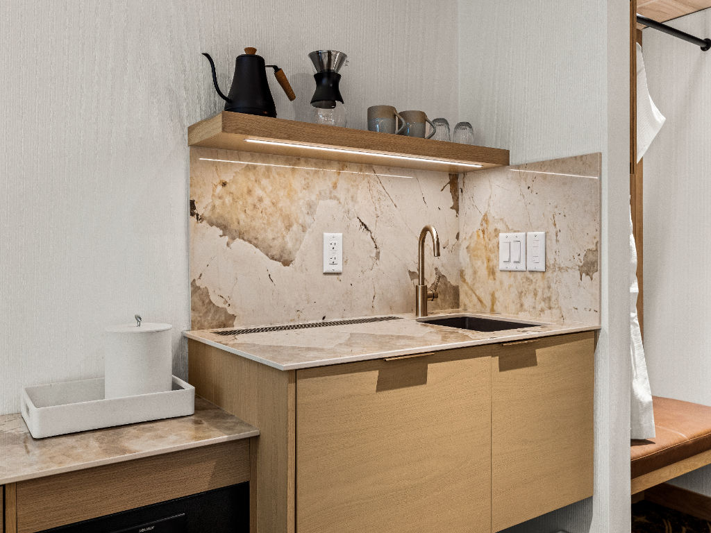 image A compact and functional kitchenette with modern finishes and warm textures, designed for convenience and comfort during your stay.