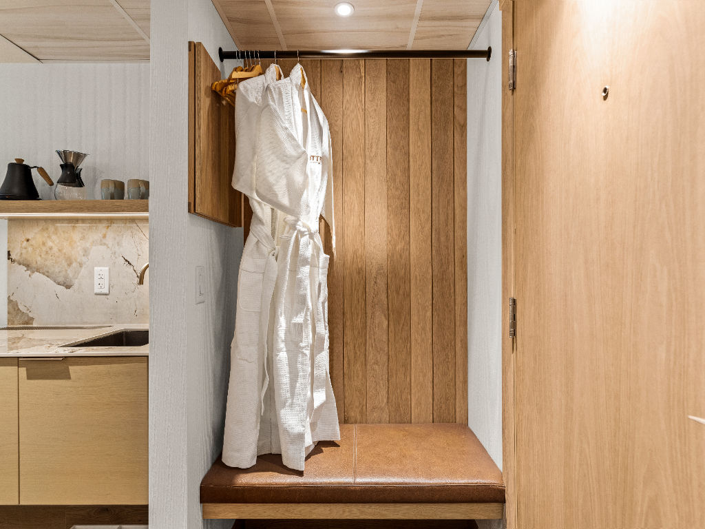 image A cozy and well-lit wardrobe nook with elegant wooden details, providing a convenient and stylish space for storing your belongings.