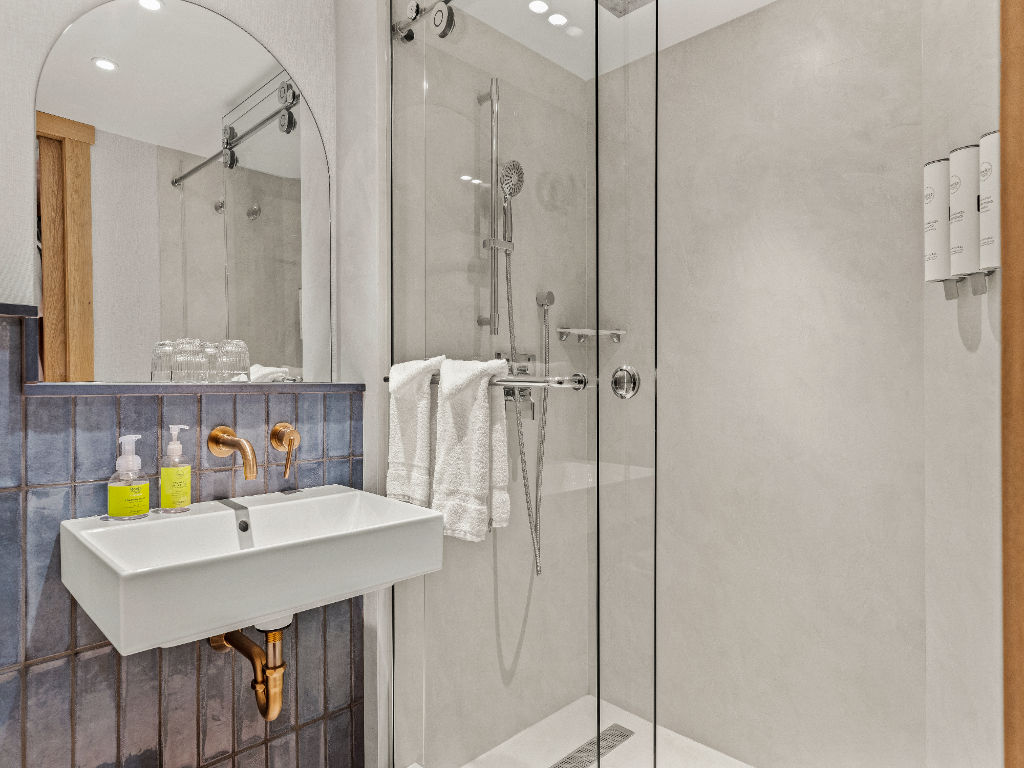 image A sleek and modern bathroom with a walk-in shower and minimalist design, offering a refreshing and calming space.