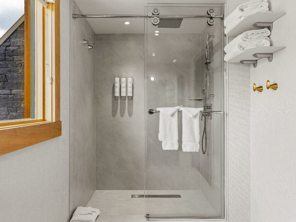 image A sleek bathroom with a walk-in shower and natural light, creating a refreshing and relaxing experience.