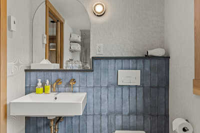 A modern bathroom with stylish tiles and a clean design, creating a calming and refreshing space to unwind.
