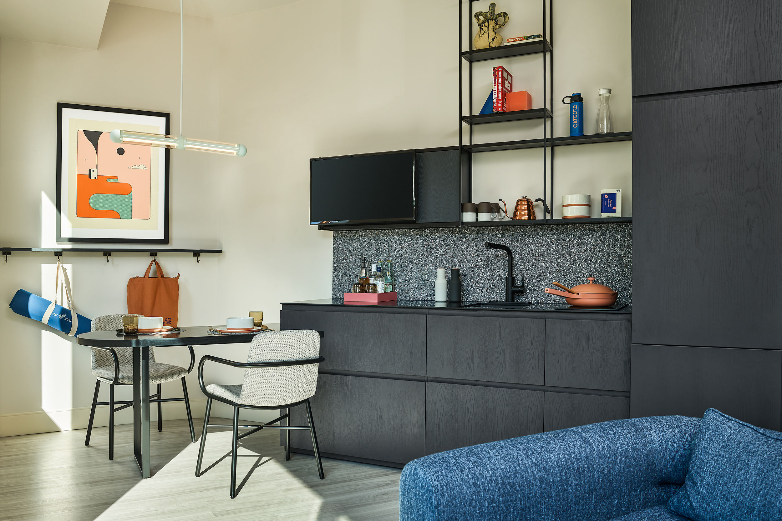 image A well-equipped kitchenette paired with a stylish dining area, perfect for enjoying meals or unwinding with a drink.