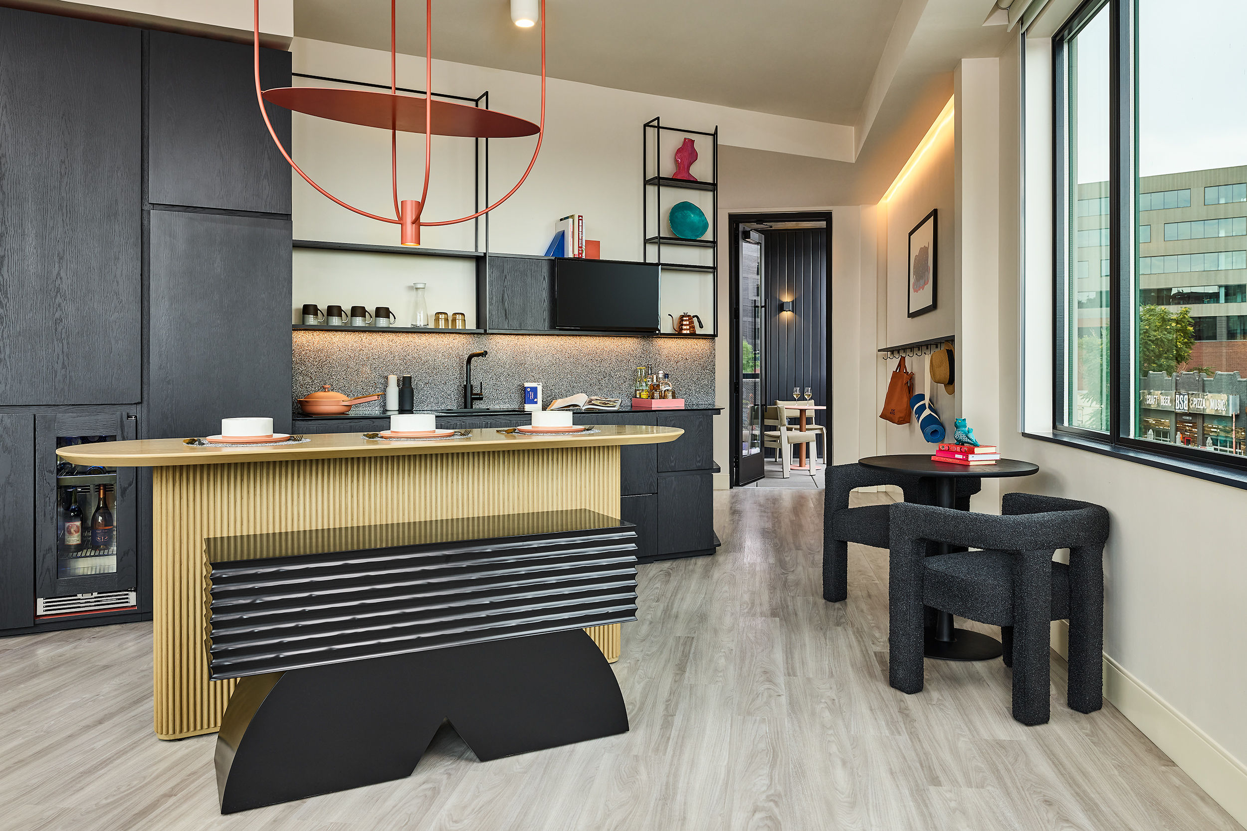 image A thoughtfully designed dining and kitchen area, blending contemporary aesthetics with practical comfort for a seamless stay.