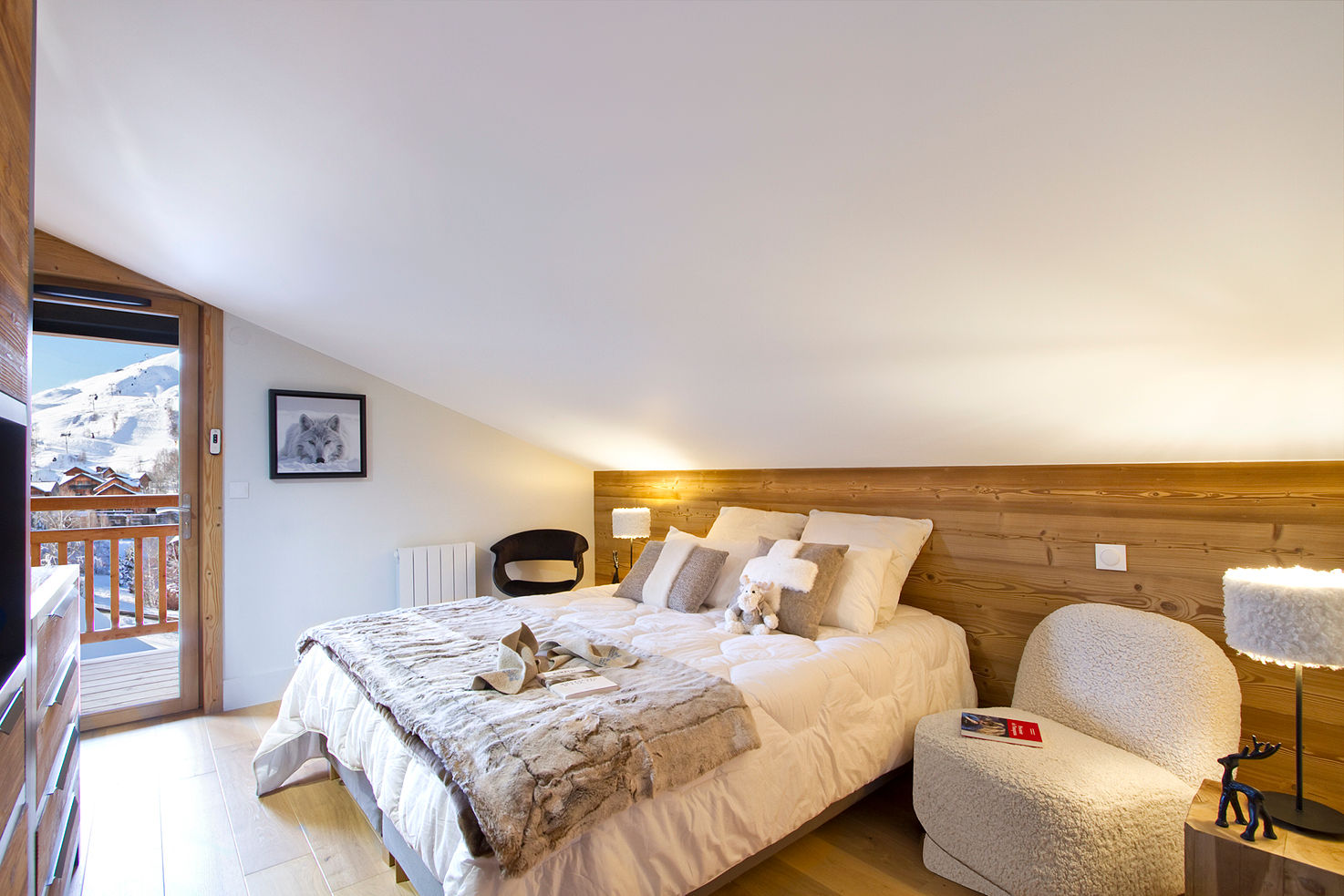 image Spacious and inviting bedroom with a cosy double bed, surrounded by warm wooden accents.