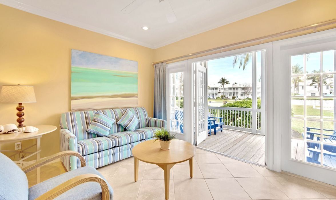 image Living room with striped sofa and French doors to a water view