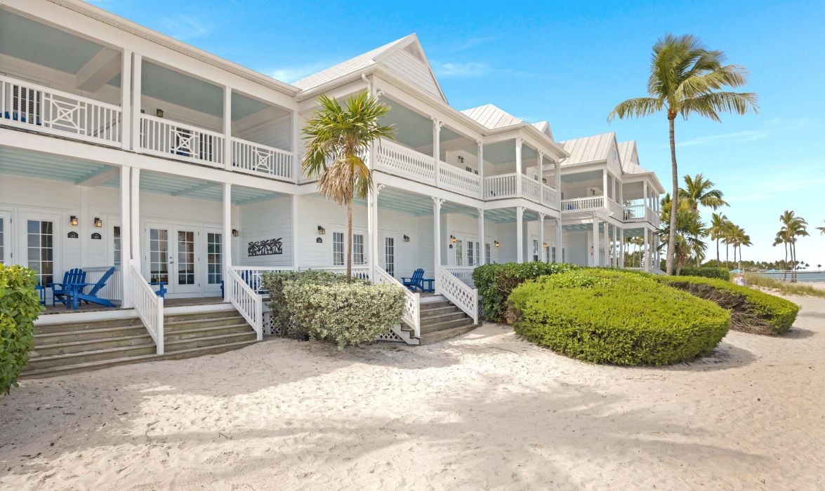 image Exterior of white two-story villas on a beachfront lawn