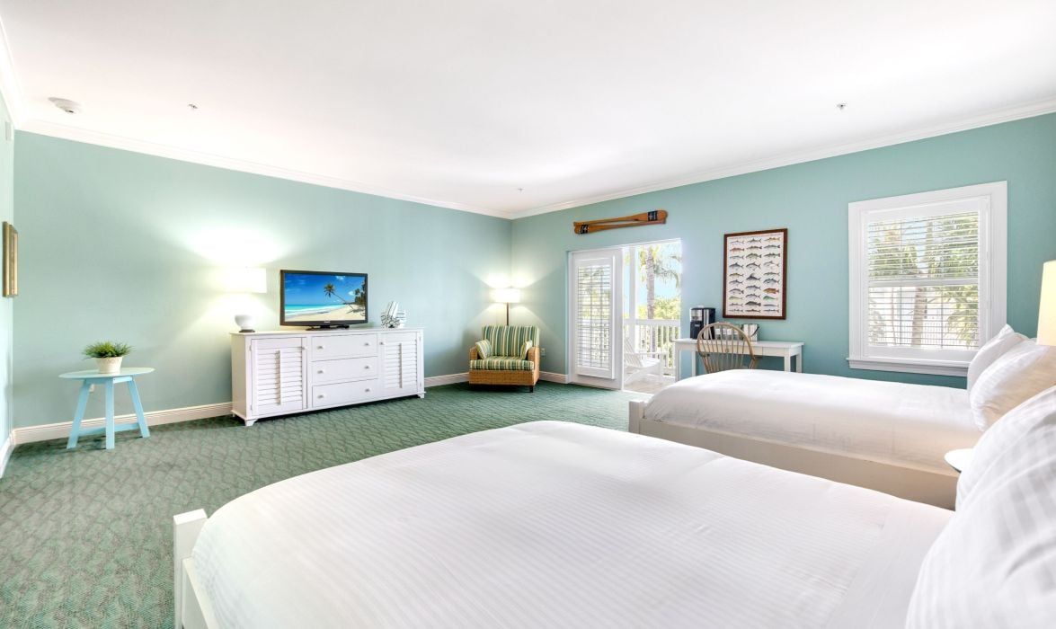 image Guest room with two queen beds, flat-screen TV, and chair