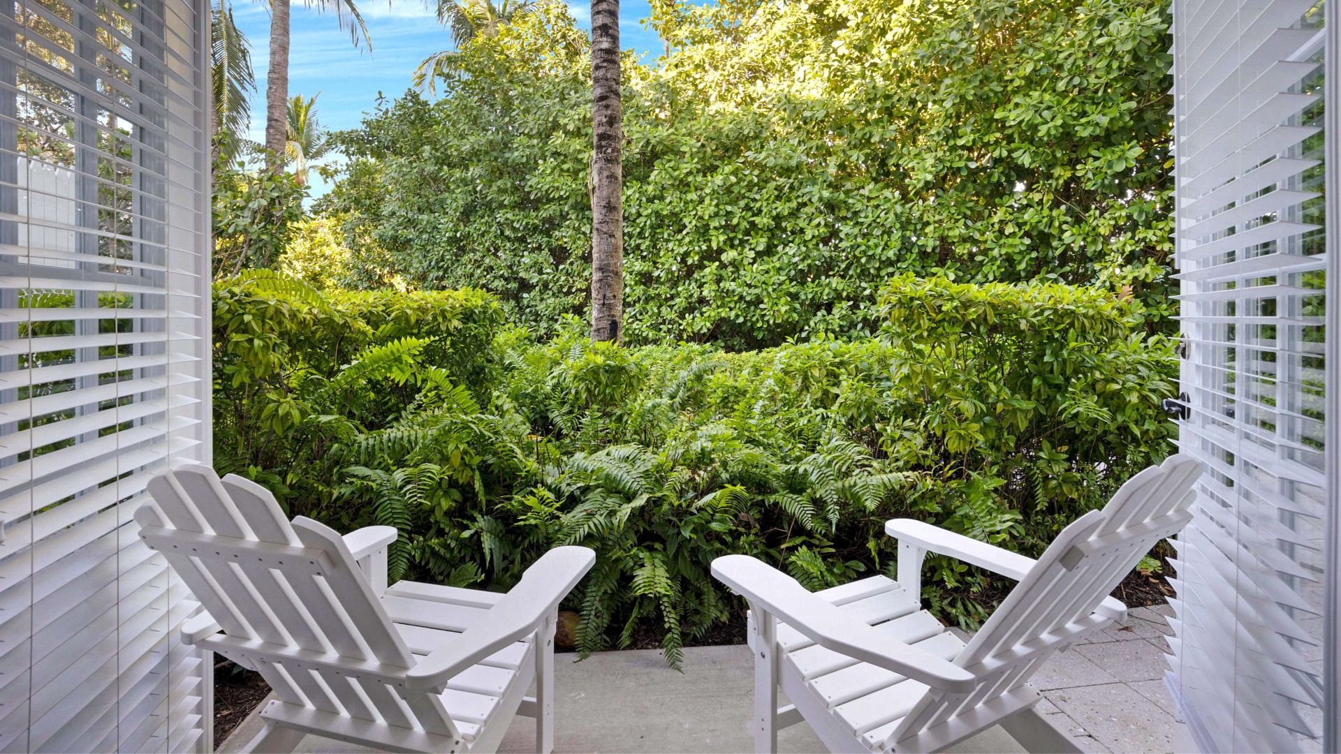 image Private patio seating with peaceful tropical garden views