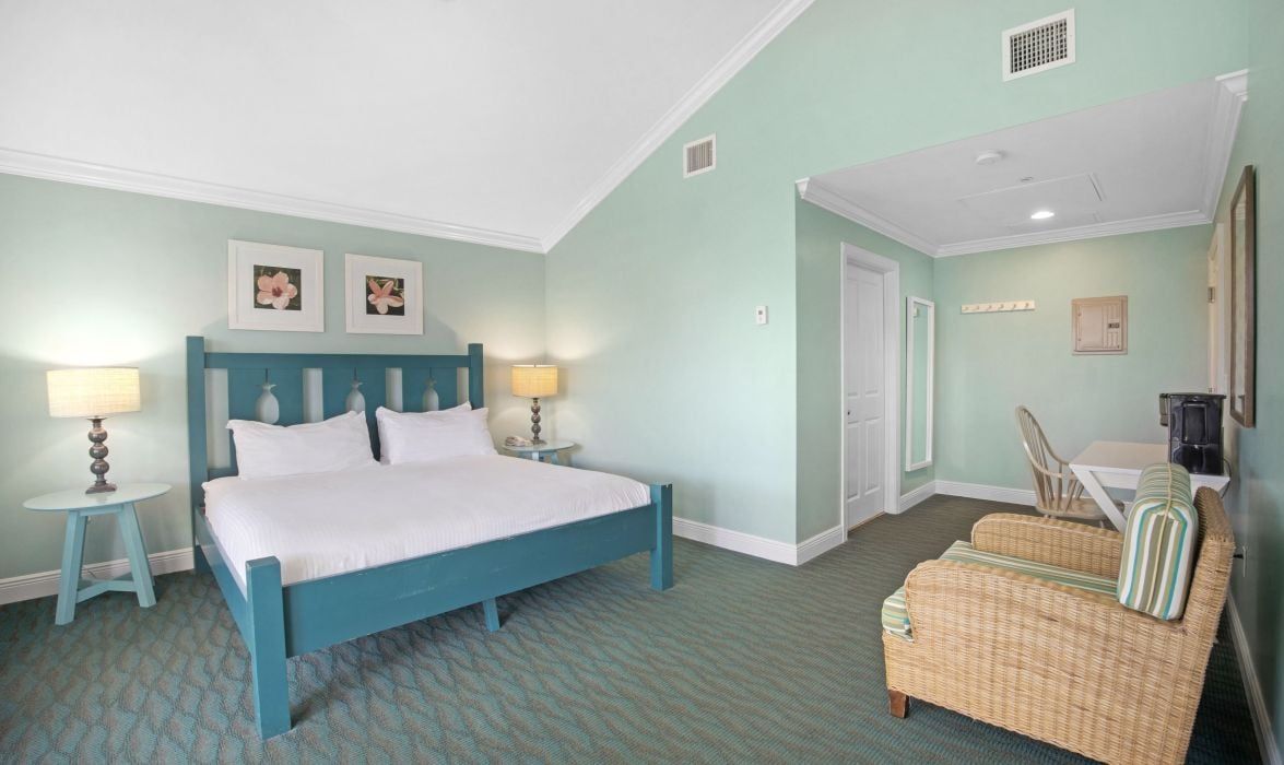 image King bedroom with table lamp and armchair