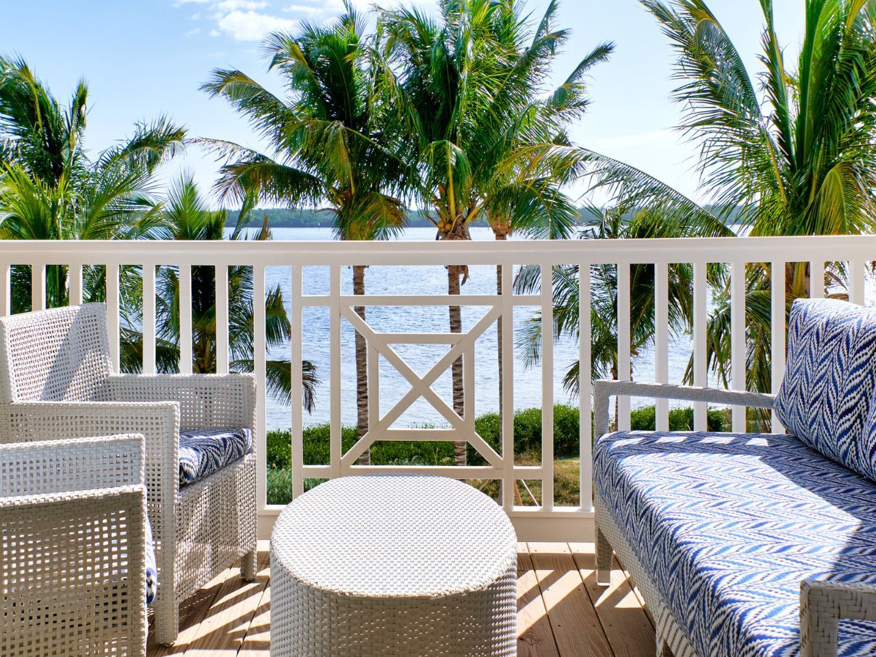 image Cozy balcony seating with lush palm views creates a relaxing spot to enjoy the outdoors.