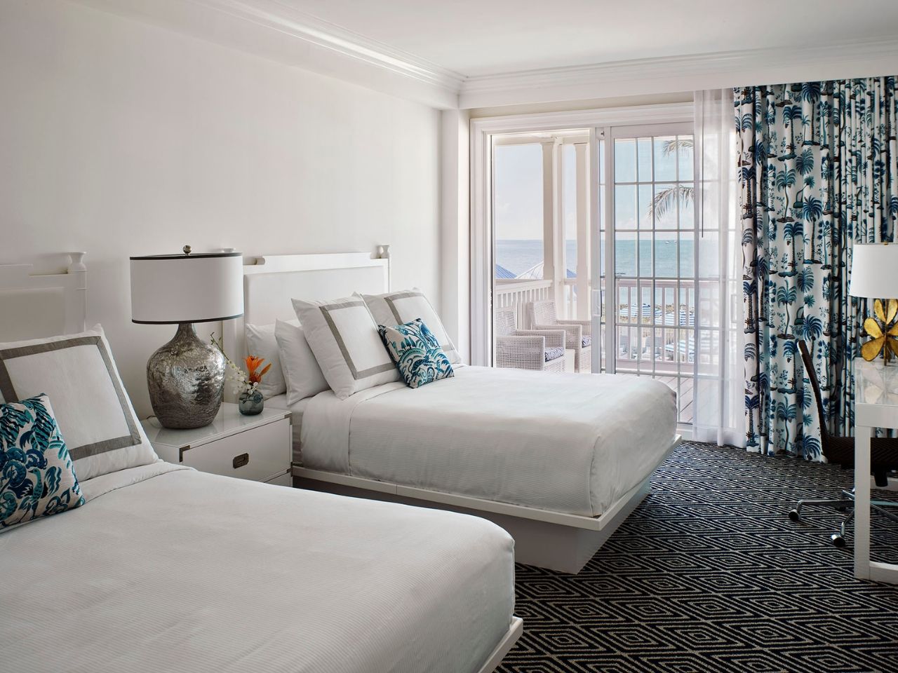 image Bright and inviting bedroom with plush beds and vibrant coastal accents, perfect for unwinding.