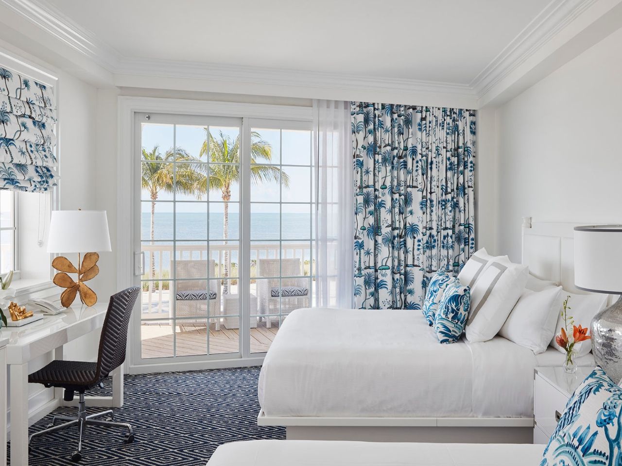 image Light-filled bedroom with soft coastal touches and floor-to-ceiling windows overlooking the water.