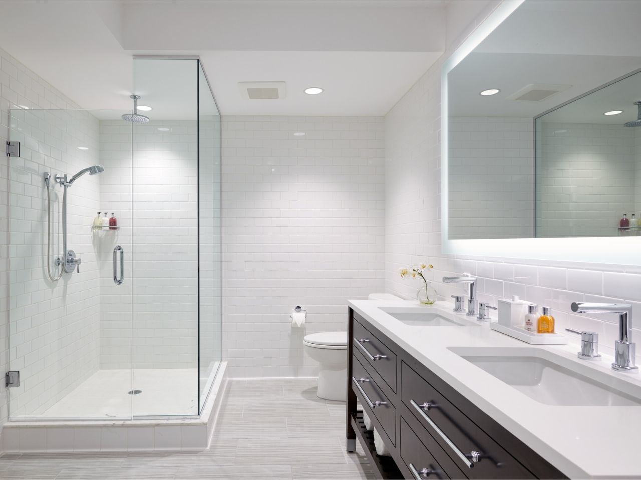 image Sleek and modern bathroom featuring a spacious glass shower and elegant dual vanity.