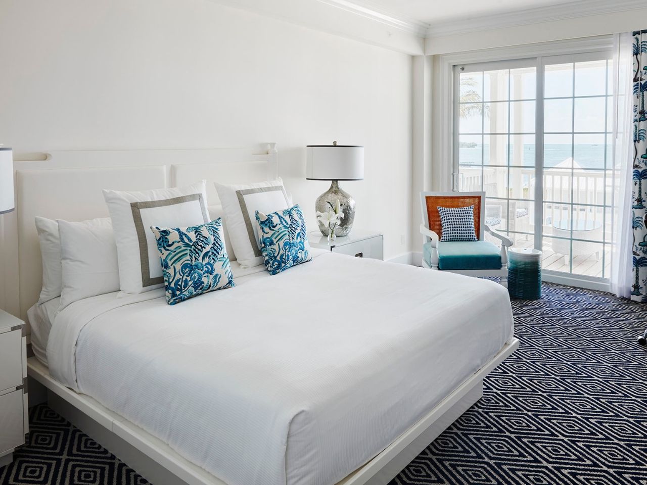 image Cozy and refined bedroom with plush bedding and ocean-inspired accents, offering ultimate relaxation.
