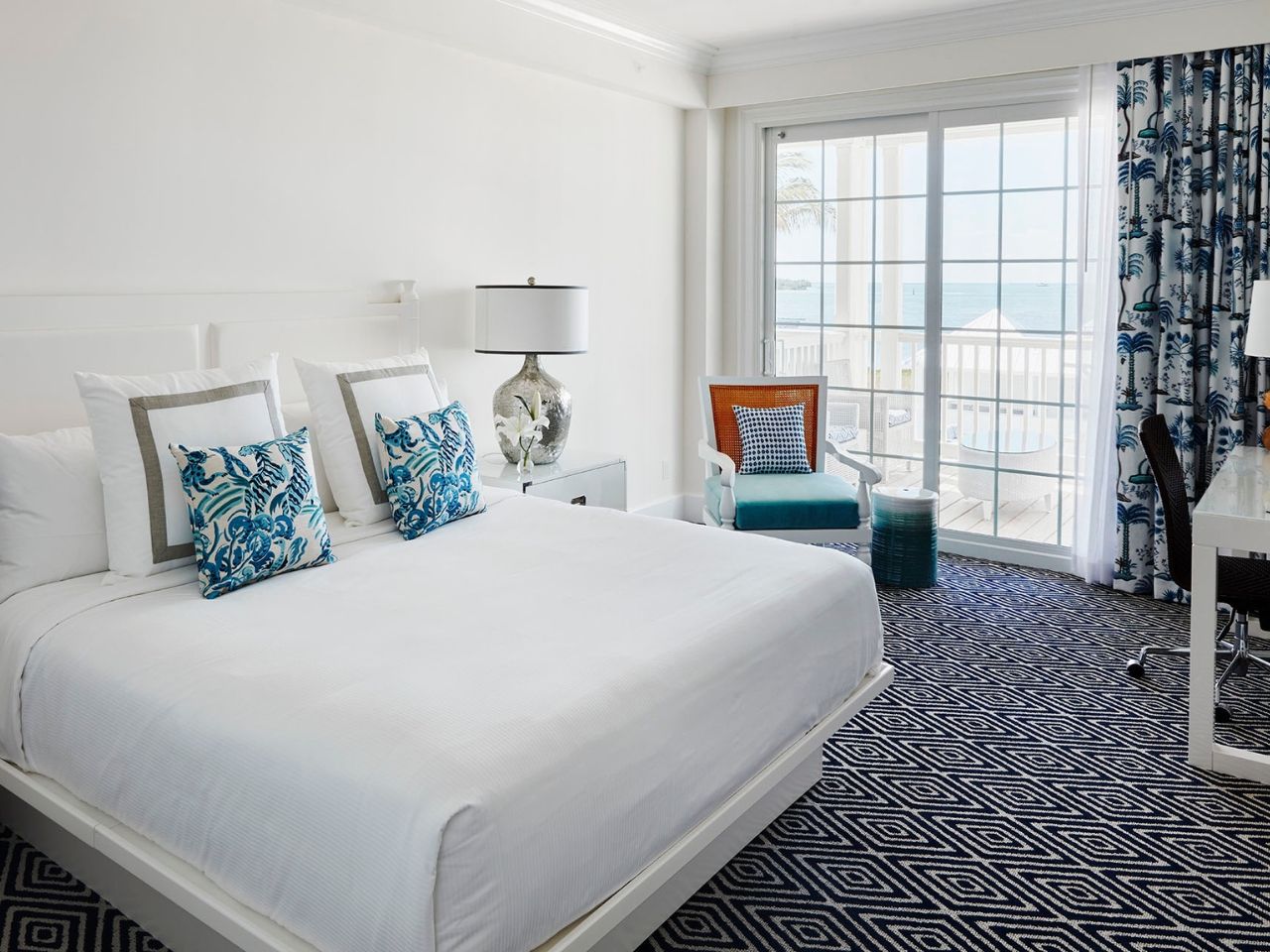 image Spacious and bright bedroom with soft hues and expansive windows overlooking tranquil surroundings.