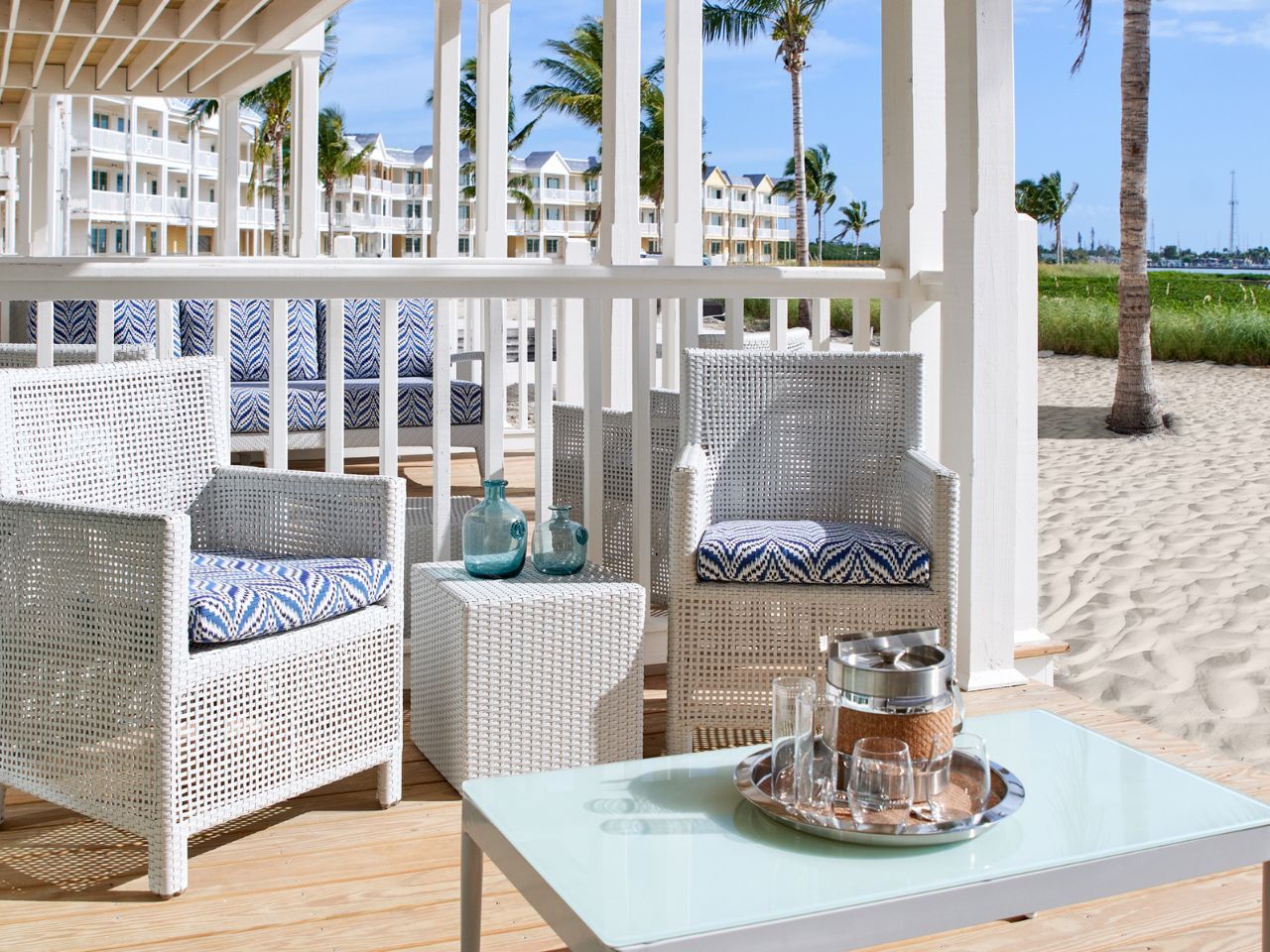 image Charming beachfront patio with comfortable seating, offering a perfect spot to unwind by the sand.