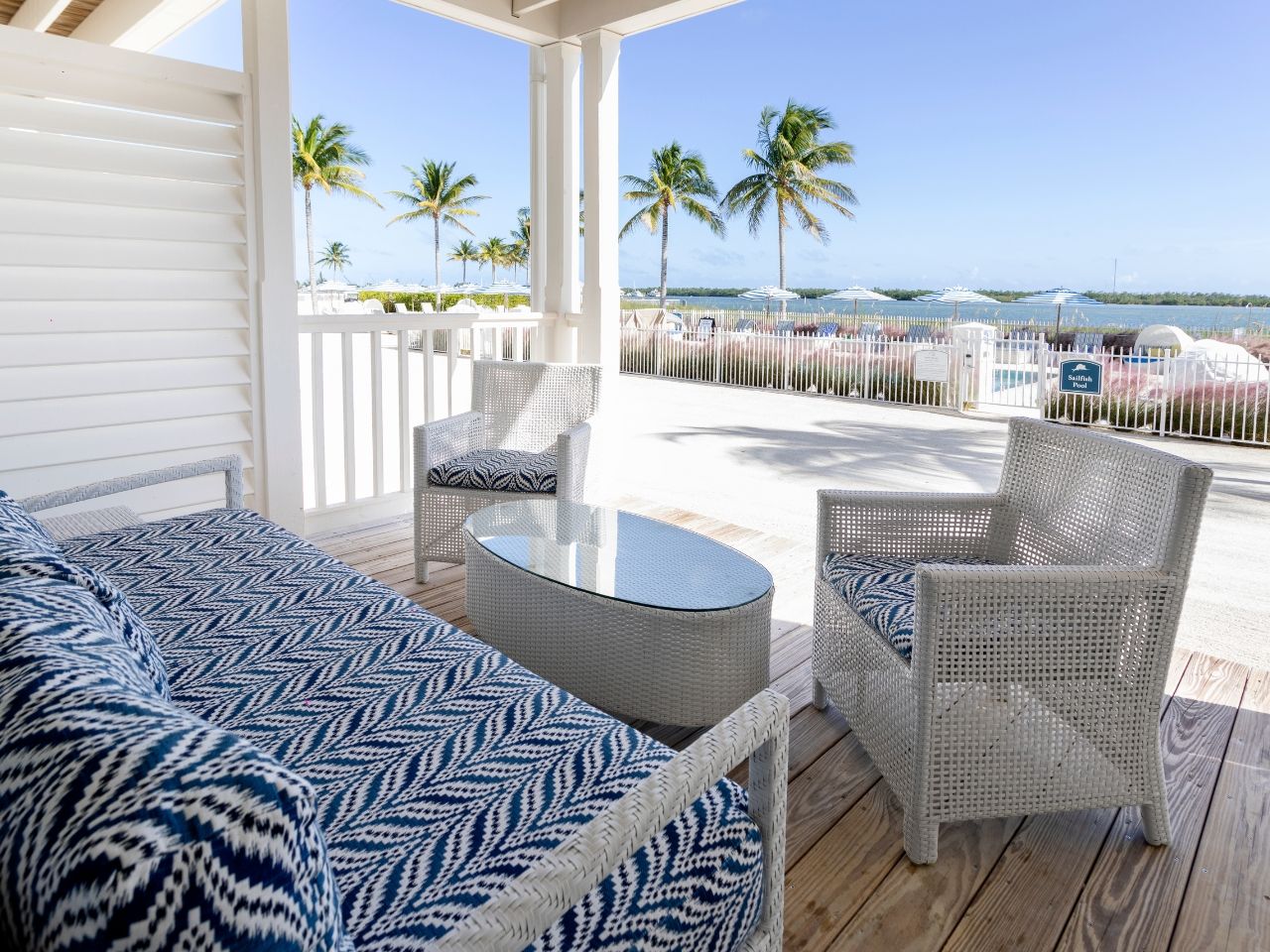 image Cozy patio with comfortable seating and breathtaking beach views, perfect for relaxing by the ocean.