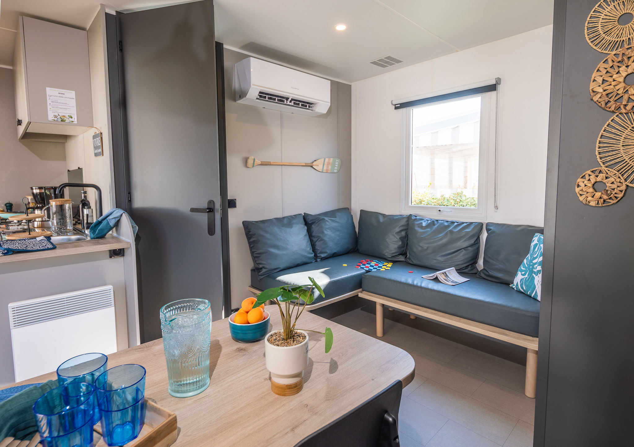 image The modern living area combines comfort and functionality, complete with a kitchenette and ample natural light.