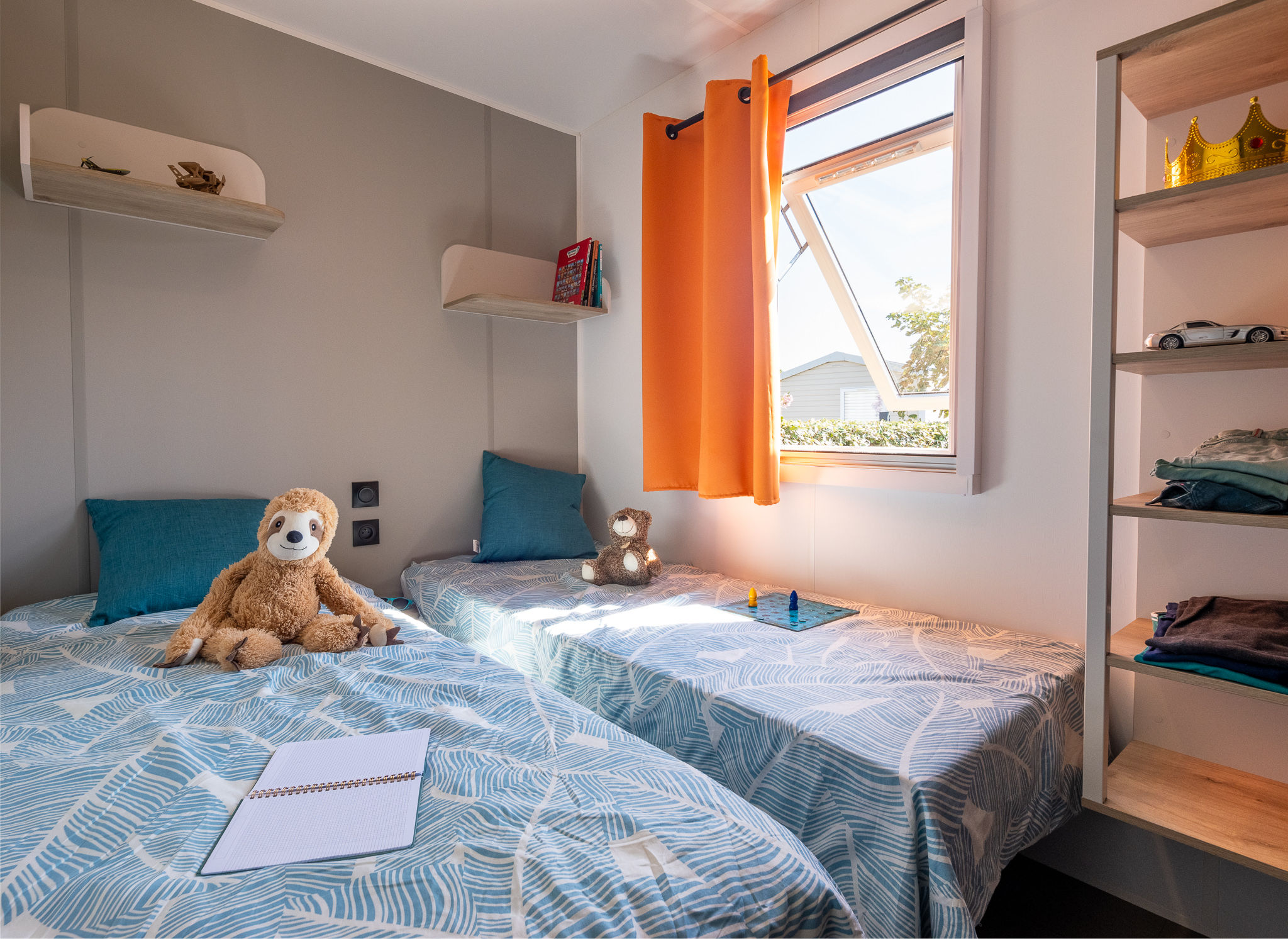 image A bright and cheerful bedroom with twin beds, ideal for kids or friends to relax after a fun-filled day.