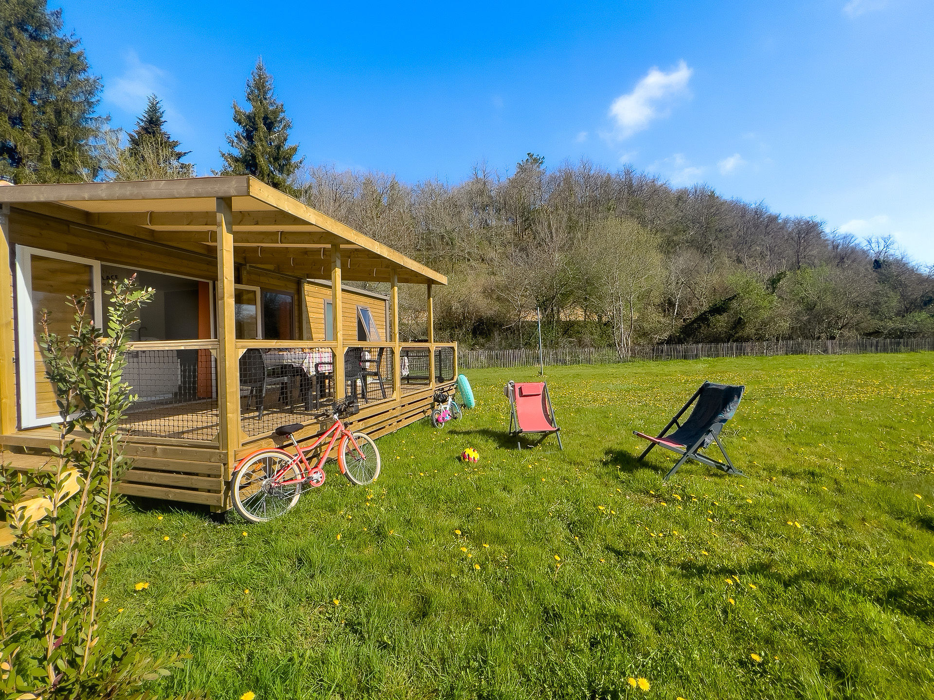 image The outdoor area beckons with its spacious lawn, perfect for family fun and relaxation, where children can play and parents can unwind under the sun.