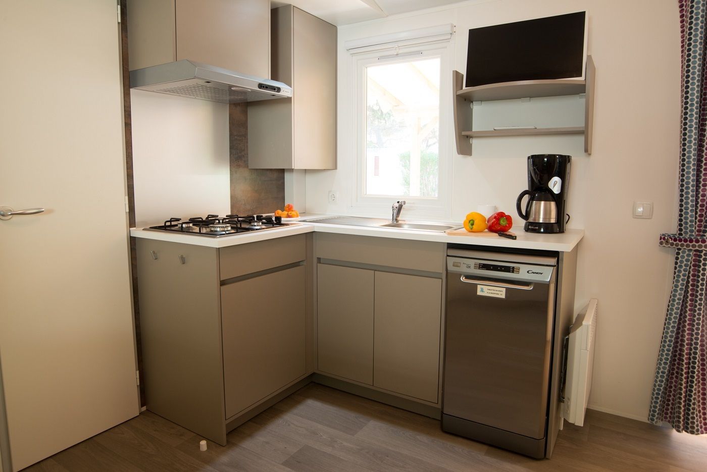 image Fully equipped kitchenette featuring a dishwasher and all the essentials for a comfortable stay.