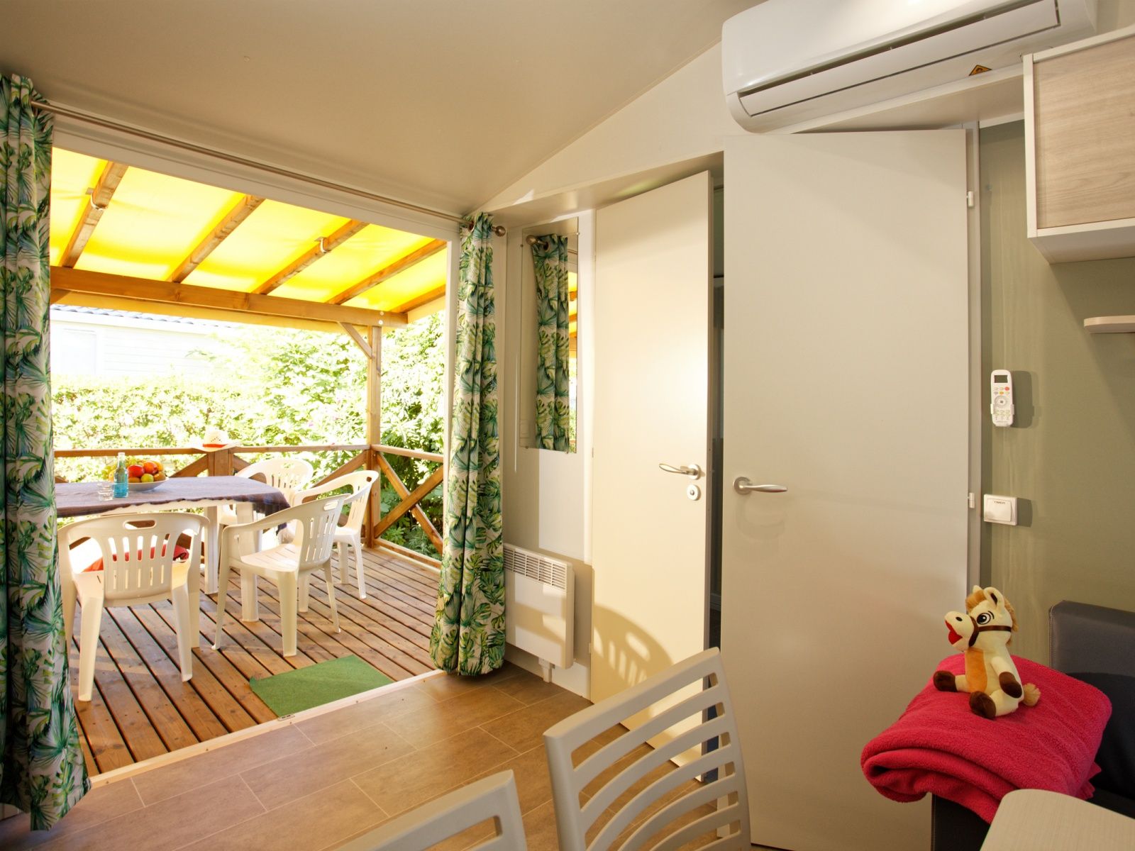 image Enjoy a bright and cosy living space with air conditioning and a covered terrace for outdoor dining.