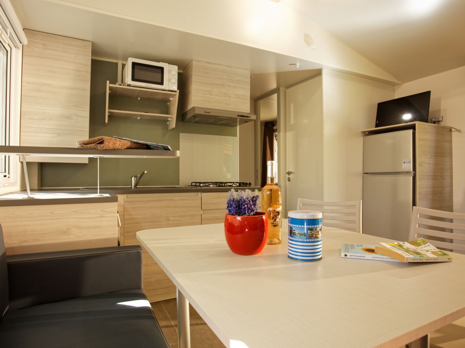 image Prepare meals and enjoy dining in the fully equipped kitchenette with a cozy dining space.