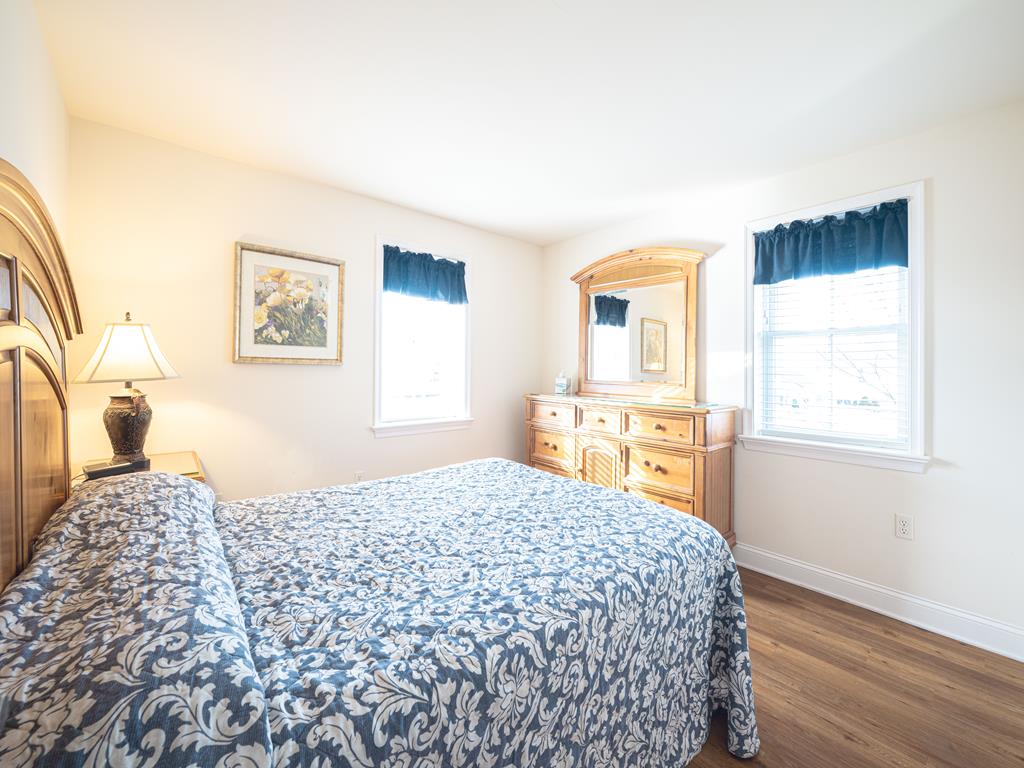 image Spacious bedroom with a queen-sized bed and plenty of natural light for a cozy, relaxing retreat.