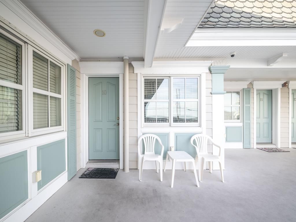 image Cozy covered patio with seating, perfect for enjoying your morning coffee or unwinding after a day at the beach.