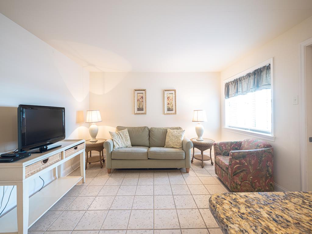 image Another angle of the comfortable living space, featuring a large window that fills the room with natural light.