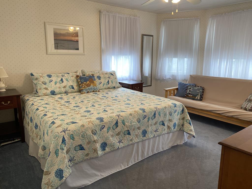 image Spacious bedroom with a king-sized bed, perfect for unwinding after a day of exploring Cape May.