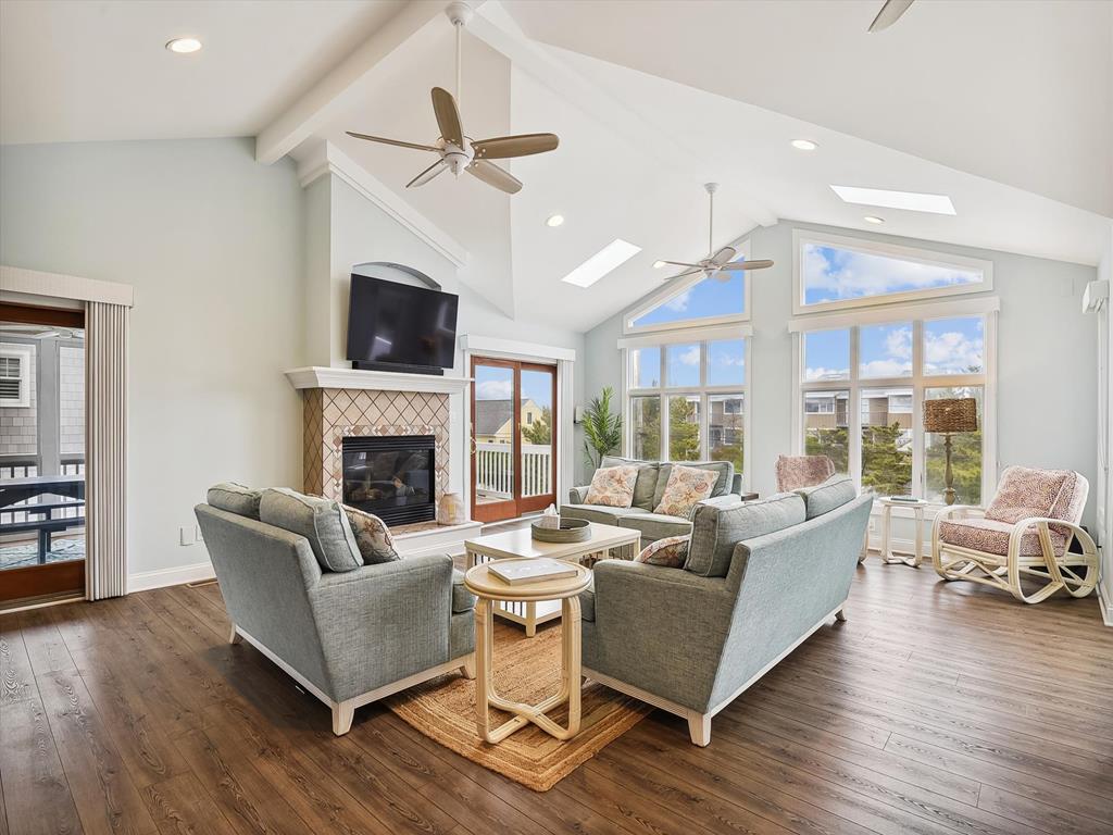 image Spacious living area with vaulted ceilings, modern furnishings, and abundant natural light.