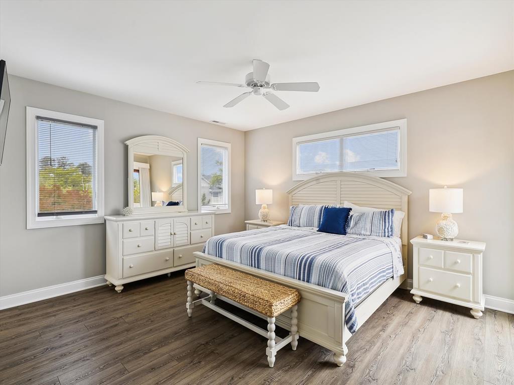 image Elegant bedroom with a plush bed, neutral tones, and large windows for a bright and airy feel.