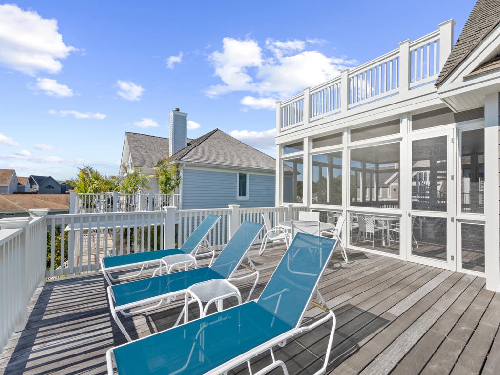 image Sun-soaked deck with comfortable lounge chairs, ideal for relaxing under the sky.