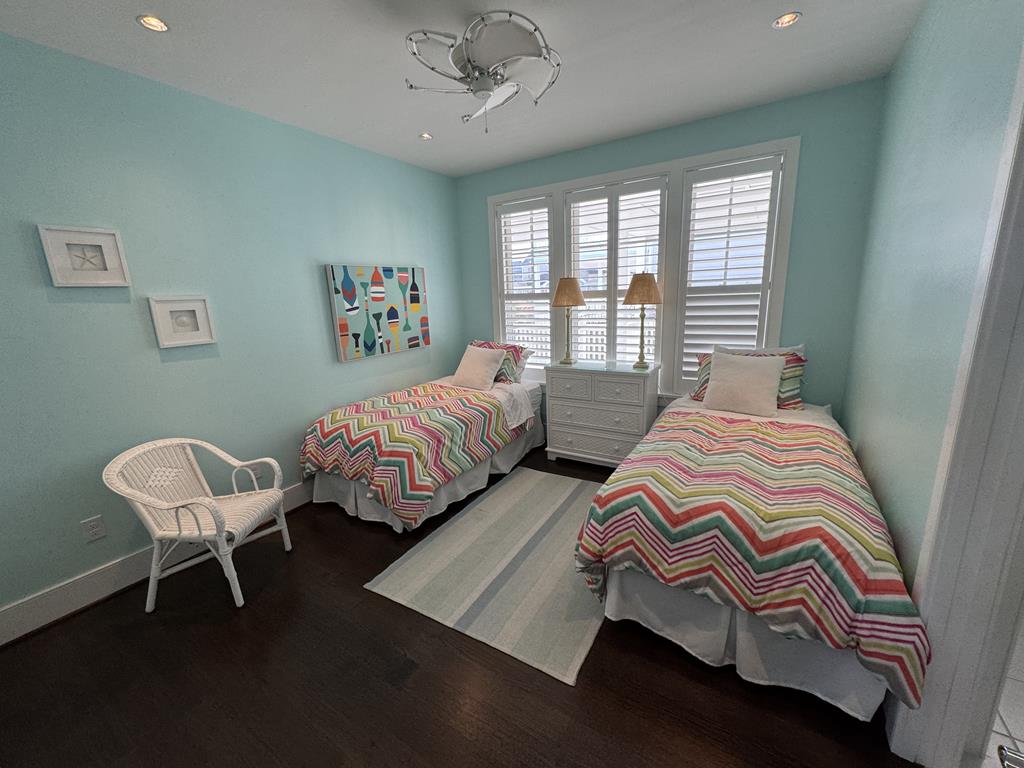 image Bright and cheerful twin bedroom with coastal decor, perfect for kids or guests.