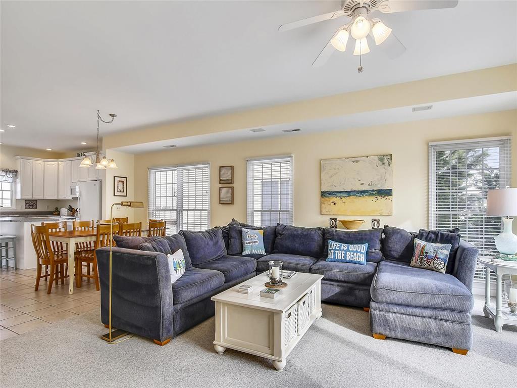 image Open-concept living room with plush seating, large windows, and smart TV for ultimate comfort.